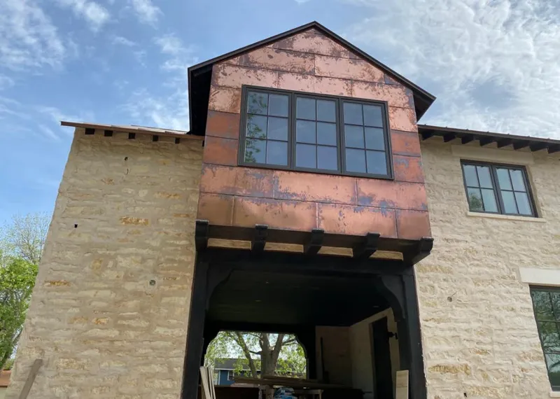 Copper metal panel facade on a stone building for Metal Roof Coating in Socastee